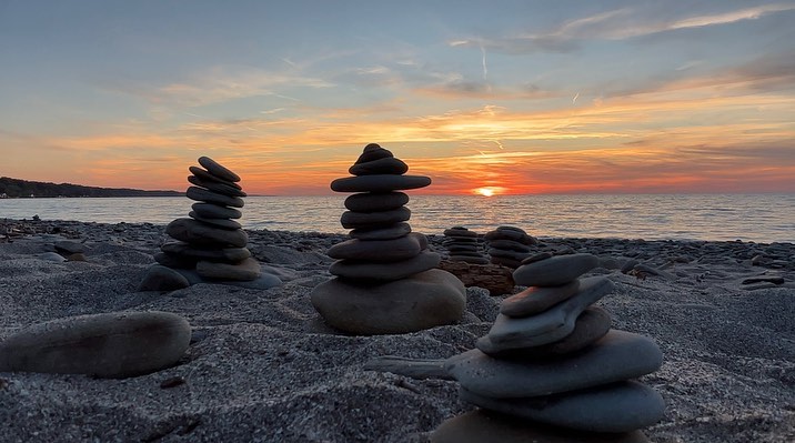 About Us - Stacked beach rocks